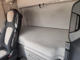two seats in the back of a van with a mattress on it