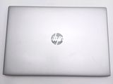a white laptop with a hp logo on the screen