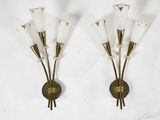 pair of brass and glass sconces with flowers on each of them