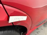 a sticker on the side of a red car that has a sticker on it