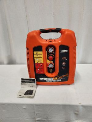 an orange and black portable air compressor sitting on top of a white table