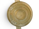 a yellow bowl with a handle on a white surface