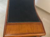 desk with a black leather pad on top of it