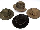 plusieurs chapeaux sont alignés sur une surface blanche
