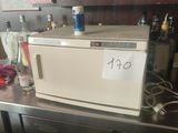 a microwave sitting on top of a counter next to bottles of alcohol