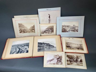 un assortiment de vieilles photos représentant des personnes et des bâtiments, posées sur une table