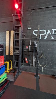 a picture of a gym room with a stack of exercise mats