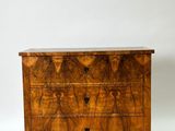 a walnut chest of drawers with three drawers on each side