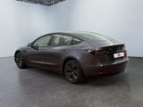 the tesla model 3 is shown in a showroom with a white wall