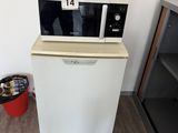 a microwave that is sitting on top of a refrigerator