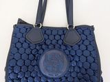 an image of a blue handbag hanging on a wall