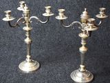 pair of antique silver plated candelabs on black background