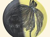 a plate with a drawing of a woman with a ponytail on it
