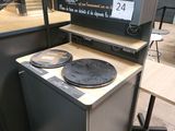 a stove with two burners on top of it in a store