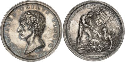 a close up of a coin with a woman and a man on it