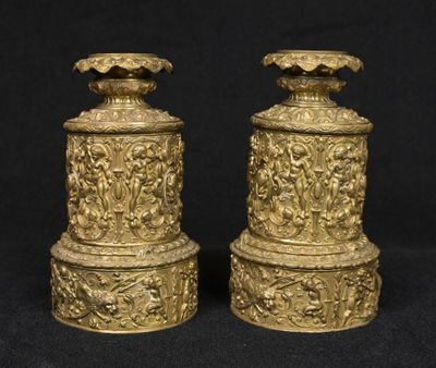 pair of antique brass vases on black background with black background