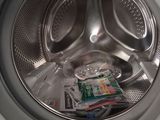 a close up of a washing machine with a lot of things inside of it