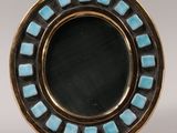 a close up of a blue and black plate on a stand
