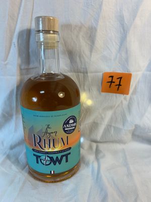 a bottle of alcohol sitting on a table with a price tag in front of it