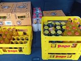 two yellow crates filled with bottles of soda sitting in the back of a car