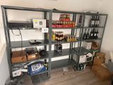 a room with a shelf full of bottles of wine and other items