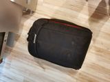 a piece of luggage sitting on the floor next to a chair