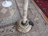 a table with a lamp on top of it on a rug