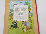 an old children ' s book with a picture of a man and a woman sitting in a park