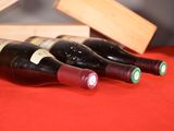 three bottles of wine sitting on a table next to a wooden box