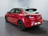 a red toyota yaris hatchback parked in a white room