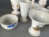 many vases and bowls sitting on a table