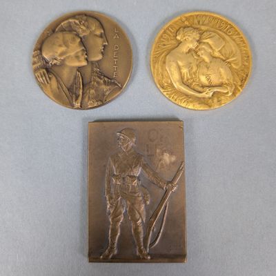 two gold coins with a woman and a man on them