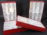 three empty wine glasses in a red gift box on a black background