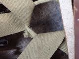 a close up of a tie on a brown bag