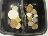 two trays with different coins in them on a table