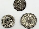 three ancient roman coins, one of which has a bust and the other of which is a bust