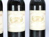three bottles of wine are lined up in a row on a table