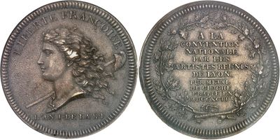 a close up of a coin with an image of a woman on it