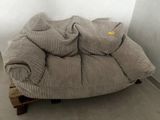 a couch that has a lot of pillows on top of it