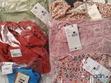 many different types of clothing on display in the store