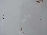 a picture of a white wall with rusted paint on it