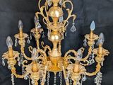 a gold chandelier with many lights hanging from it