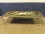a coffee table with a mosaic design on top of it