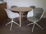 four chairs around a round table in a room