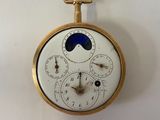 a clock that is hanging on the wall with a blue moon on it