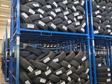 tires are stacked on pallets in a warehouse