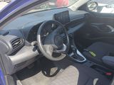 the interior of a blue car with a steering wheel and dashboard