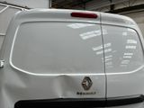 a white van parked in a garage with its door open