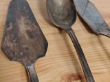three spoons and a spatula sitting on a table