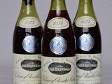 three bottles of wine are lined up on a table